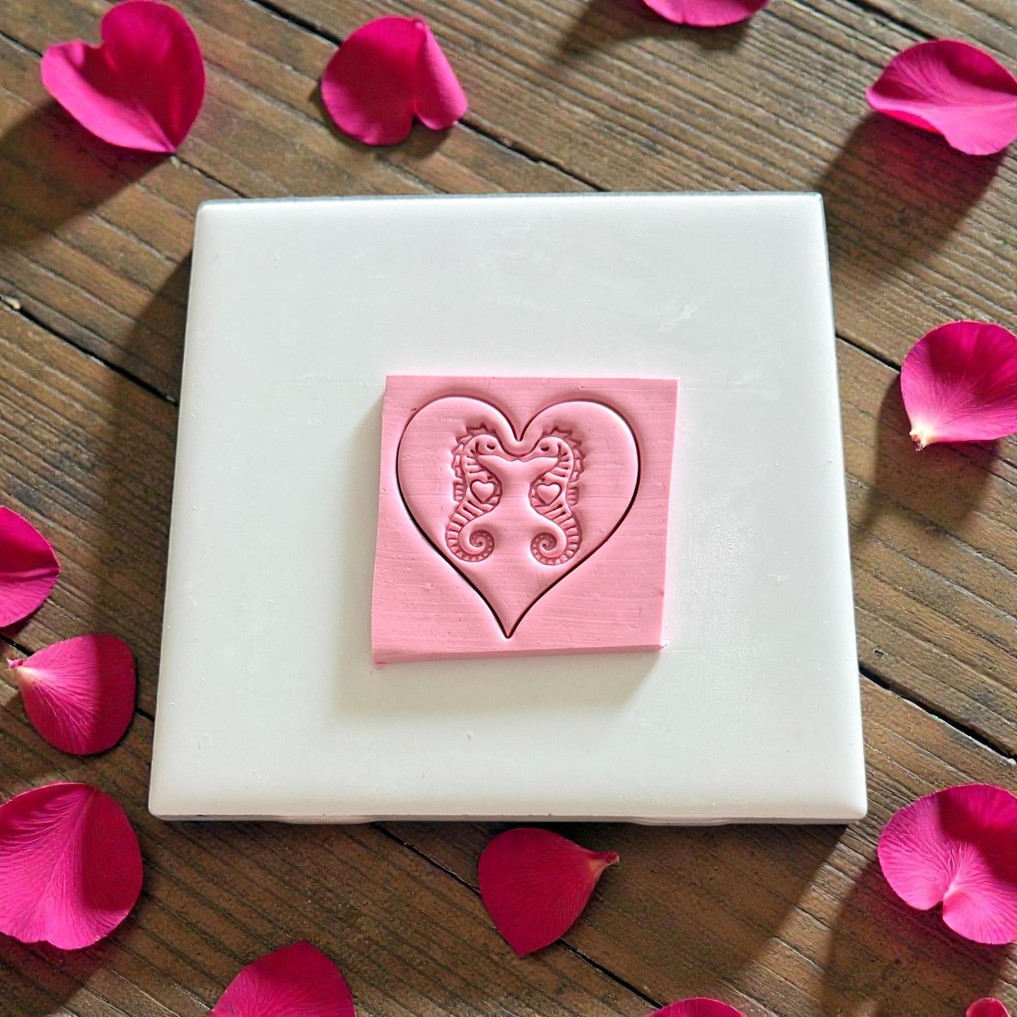 seahorse heart clay impression on white tile