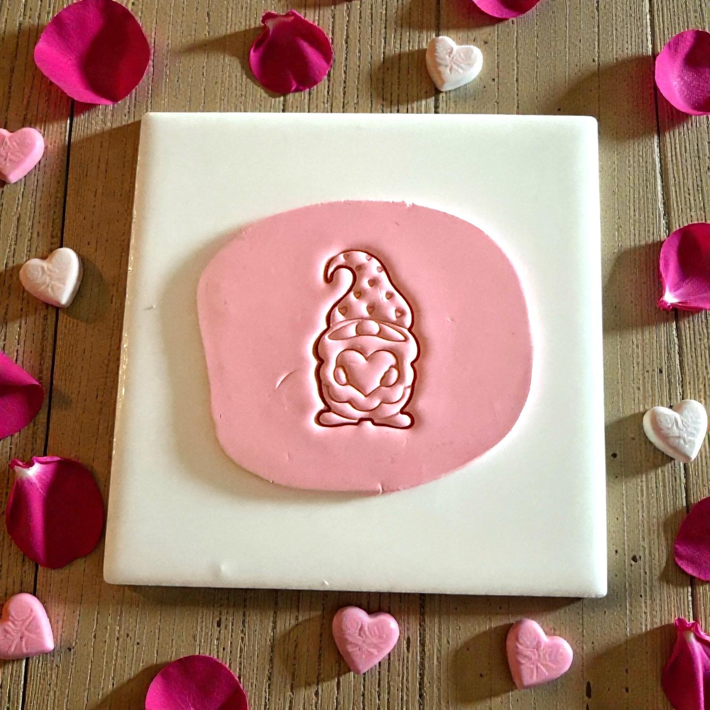 pink clay impression of Valentine gnome with heart