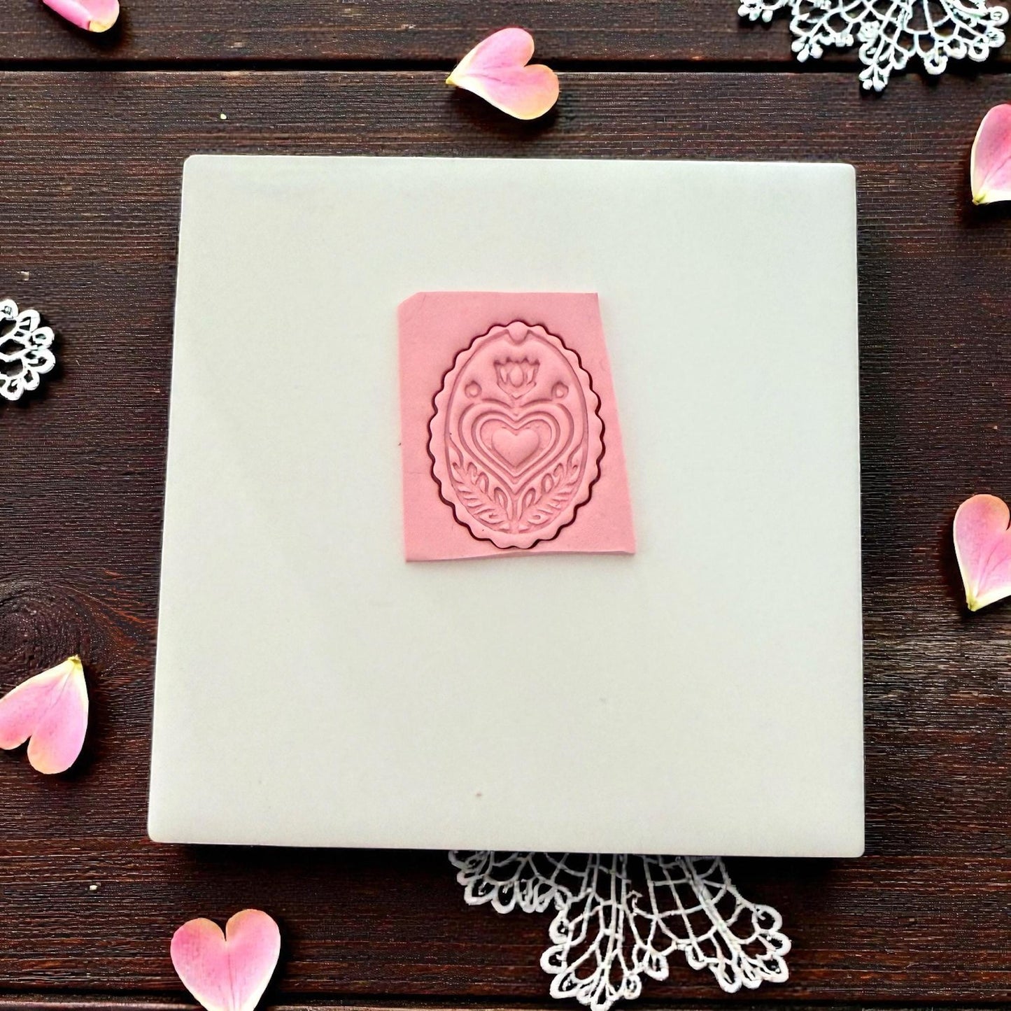 pink folk heart clay impression on tile
