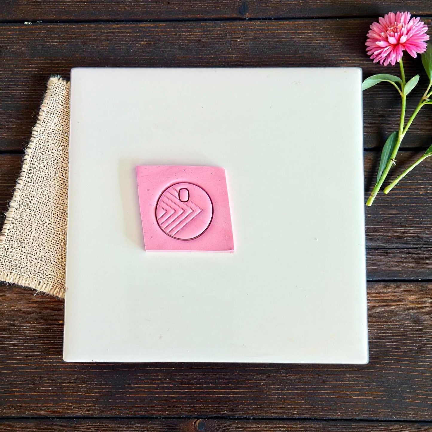 round geo arrow clay impression on pink slab