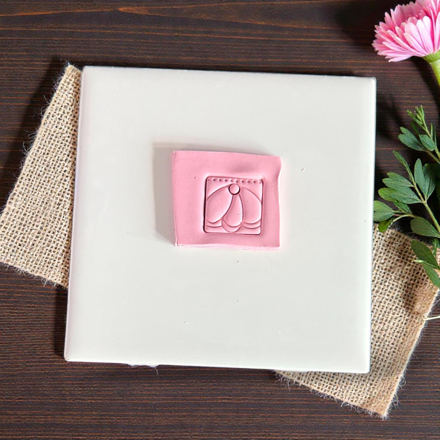 pink clay square charm with scalloped petal design