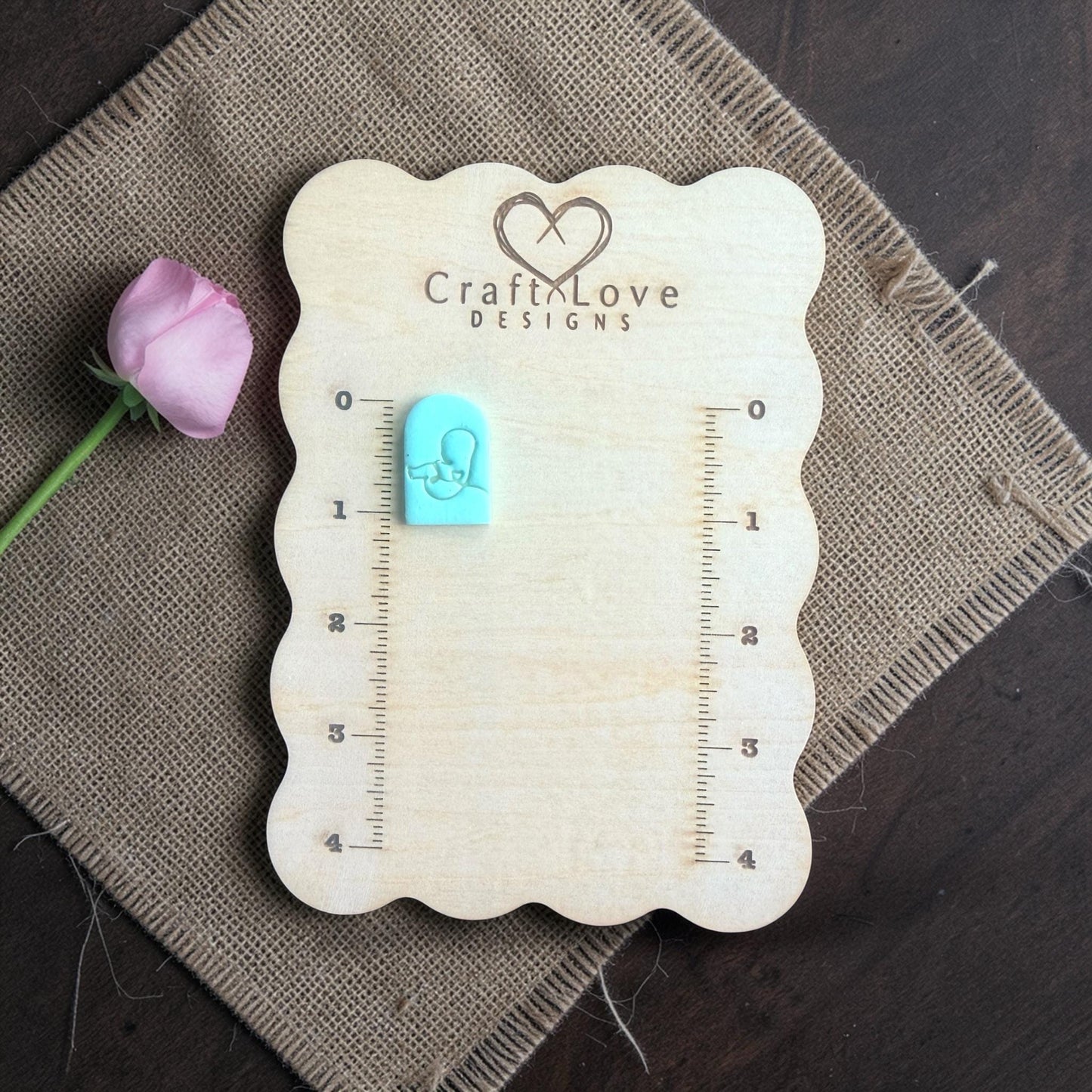 sleeping baby clay cutter shown on measurement board
