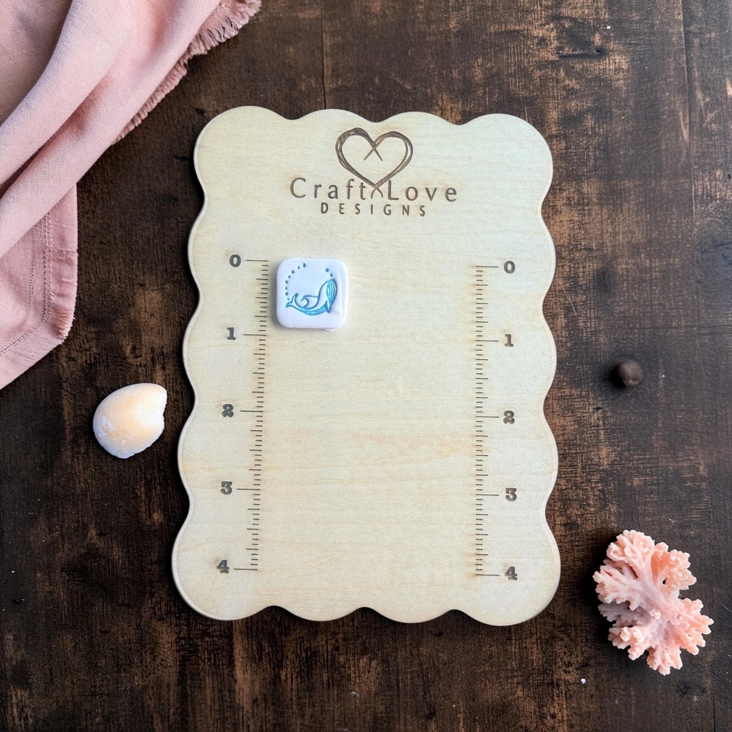 teal whale clay cutter stamped example on measuring board
