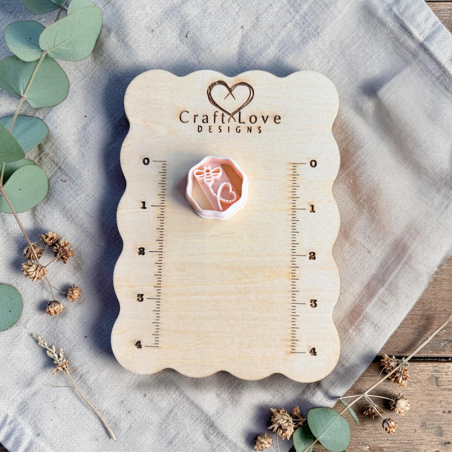 bee heart clay cutter on measuring board close view
