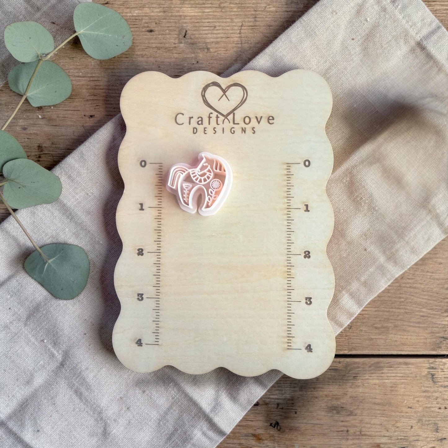 white polymer clay horse cutter displayed on Craft Love Designs ruler board