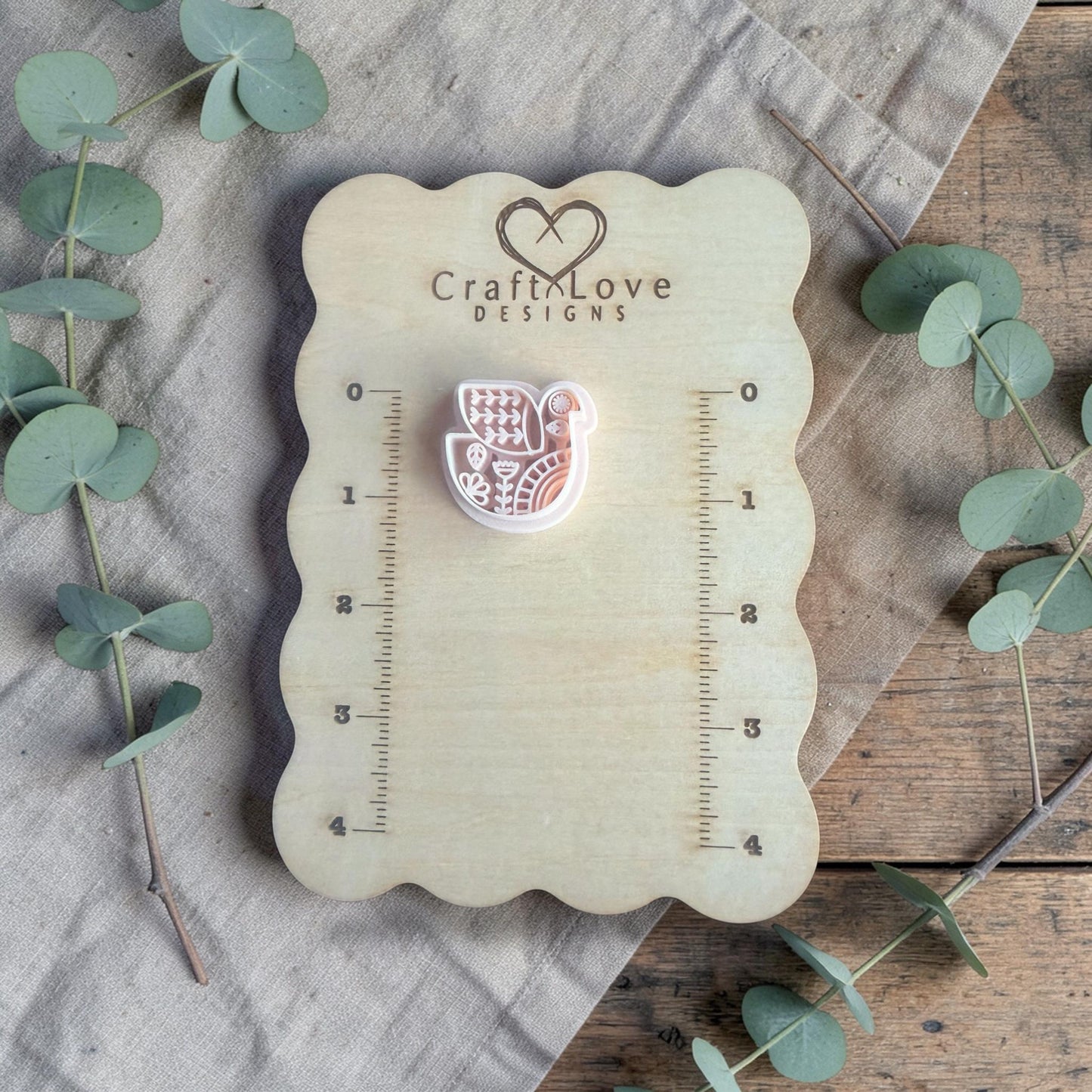 white polymer clay bird cutter displayed on Craft Love Designs ruler board