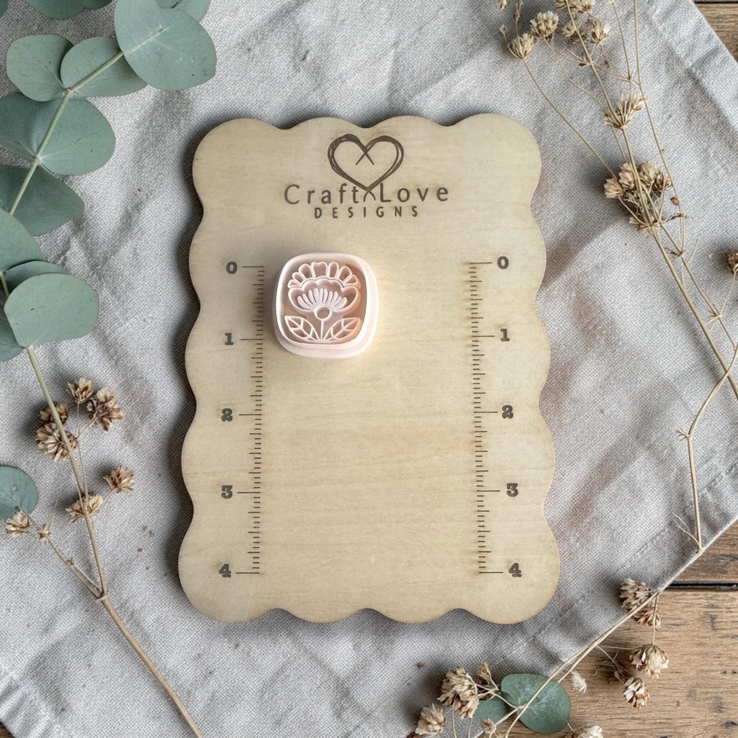 white polymer clay flower cutter displayed on Craft Love Designs ruler board