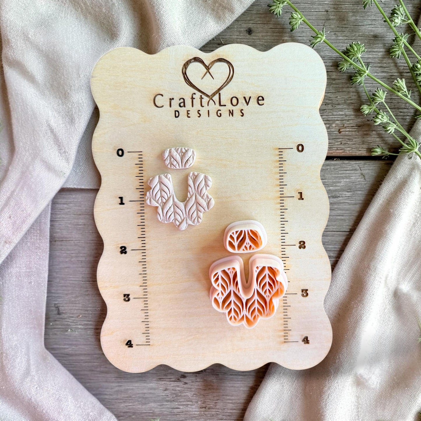 Polymer clay cutter displayed on measurement board showing scale for earring making