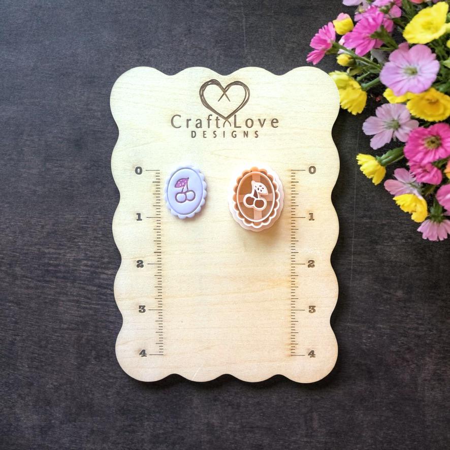 Cherry cameo polymer clay cutter on wooden size board