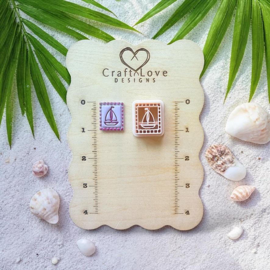 Sailboat clay cutter and pieces displayed on wooden sizing board with coastal decor