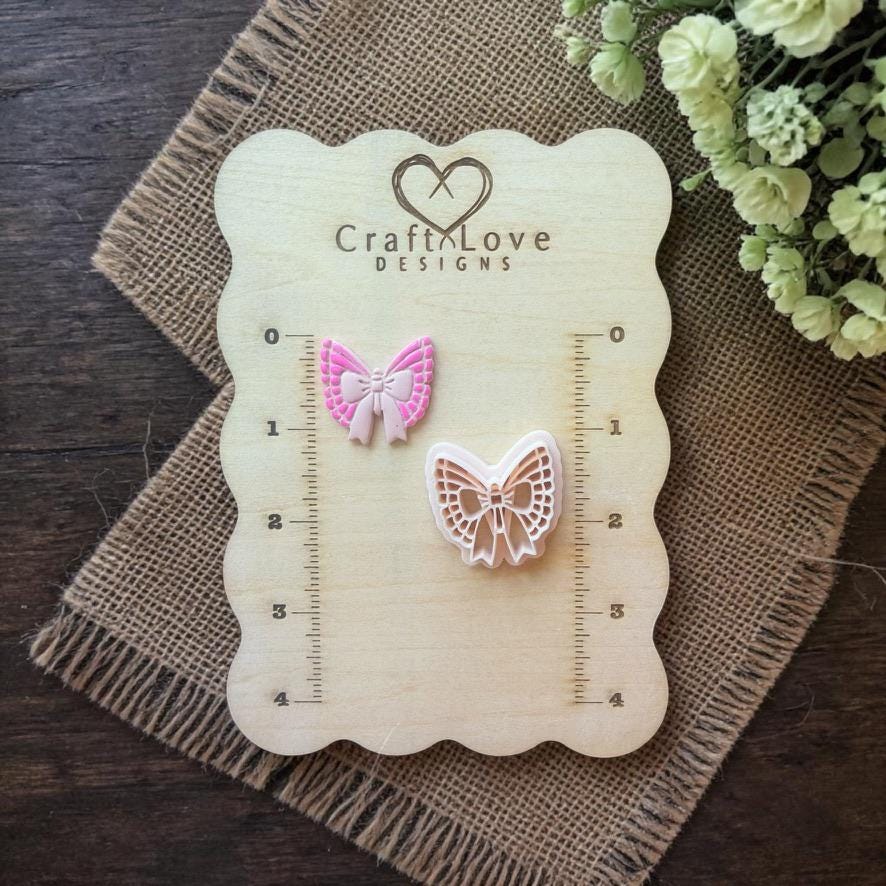 butterfly bow clay cutter displayed on wooden ruler board