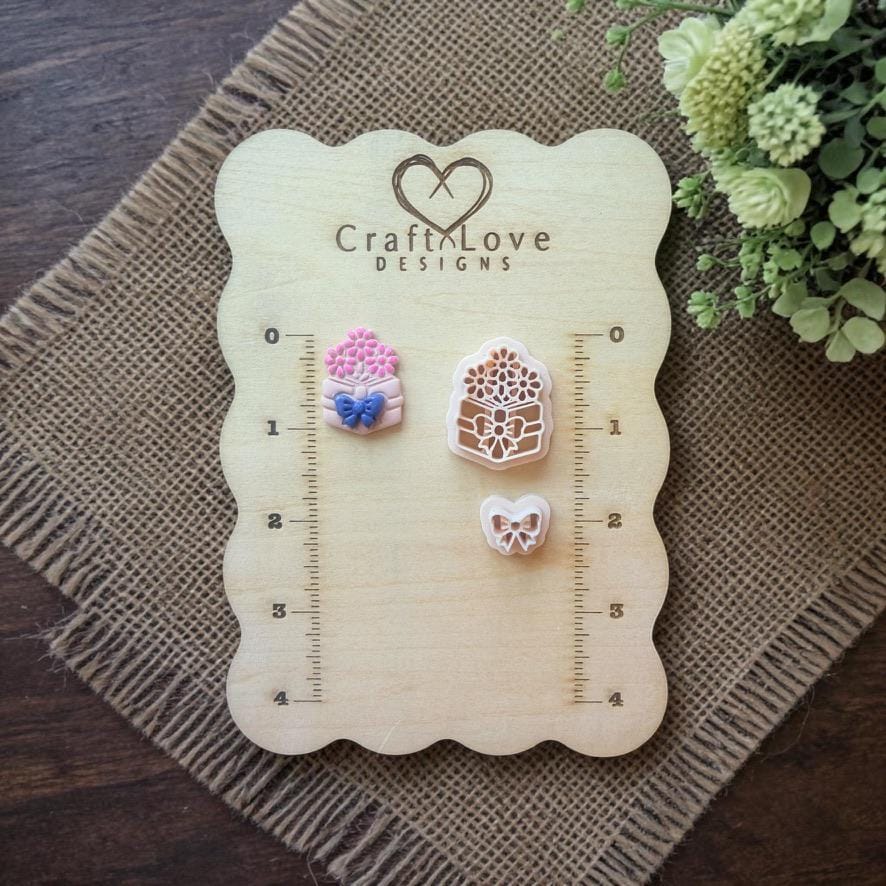 book flower and bow cutters displayed on wooden ruler board
