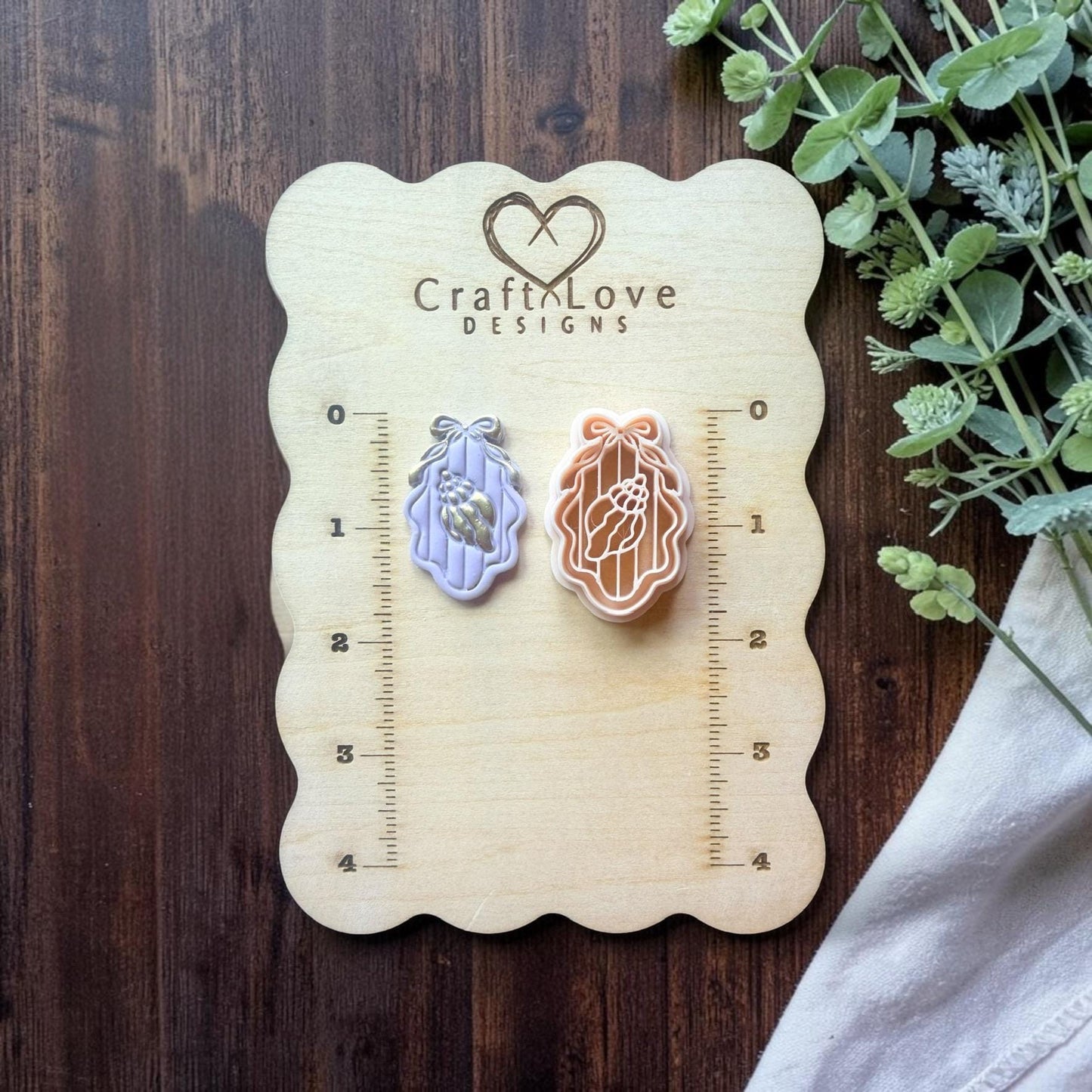 seashell cameo cutter displayed on ruler board for size reference