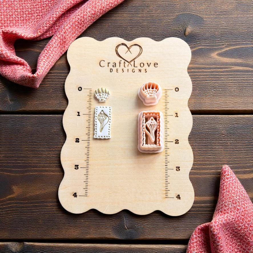 Seashell clay cutter set displayed on wooden measurement board with finished polymer clay earrings and coastal decor
