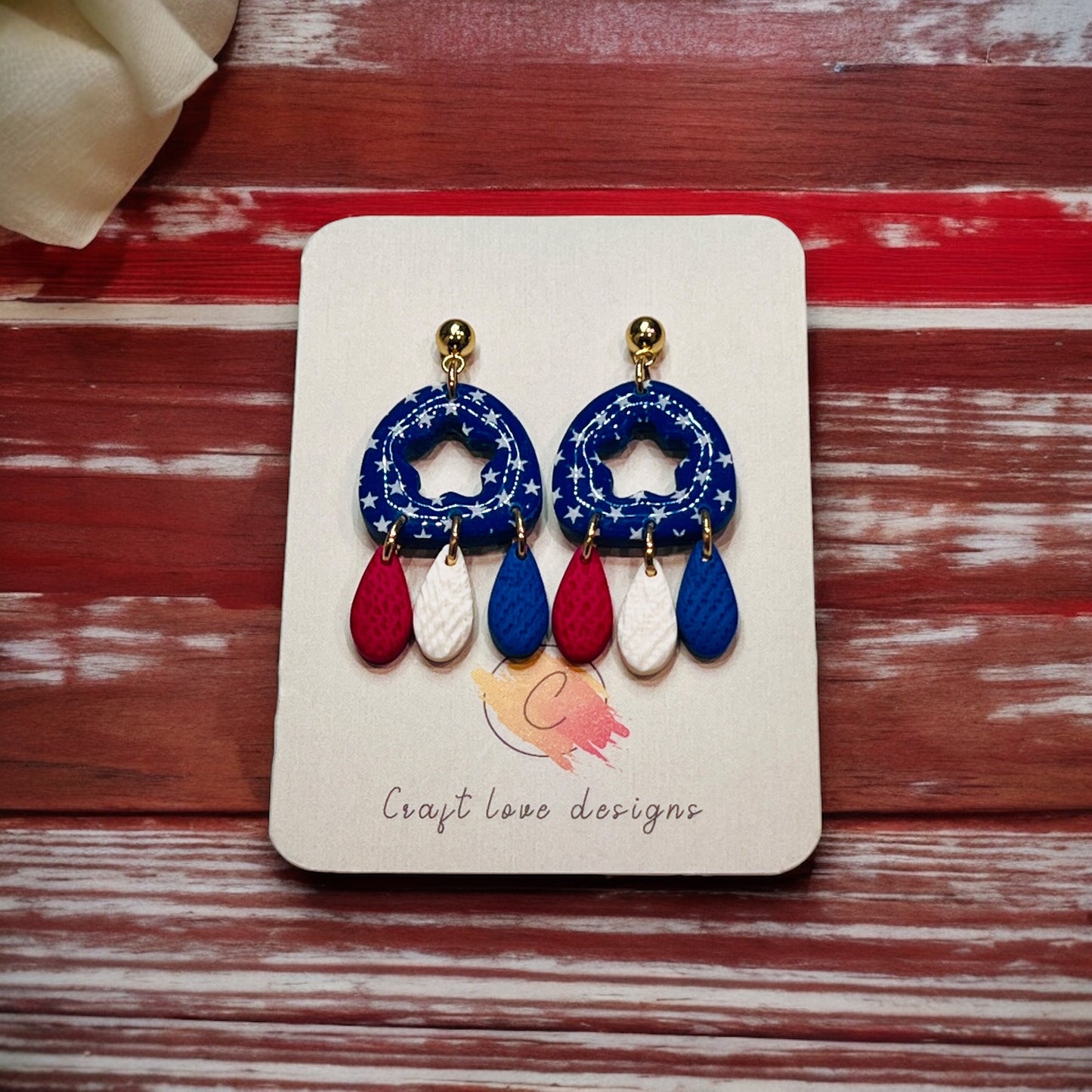 Unique 4th of July polymer clay dangle earrings featuring a patriotic red, white, and blue design, perfect for celebrations.