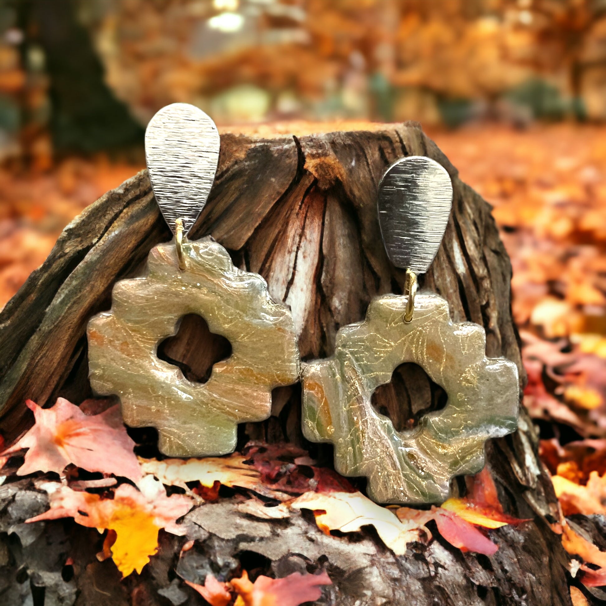 Aztec-style dangle earrings in beige tones with fall-inspired earthy textures, hanging on a golden teardrop stud, perfect for autumn fashion.