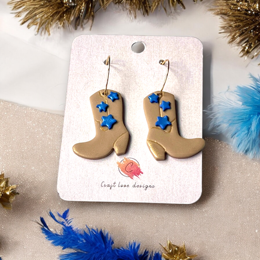 Handmade beige boot earrings featuring blue star accents, displayed on a Craft Love Designs card, ideal for country-themed outfits.