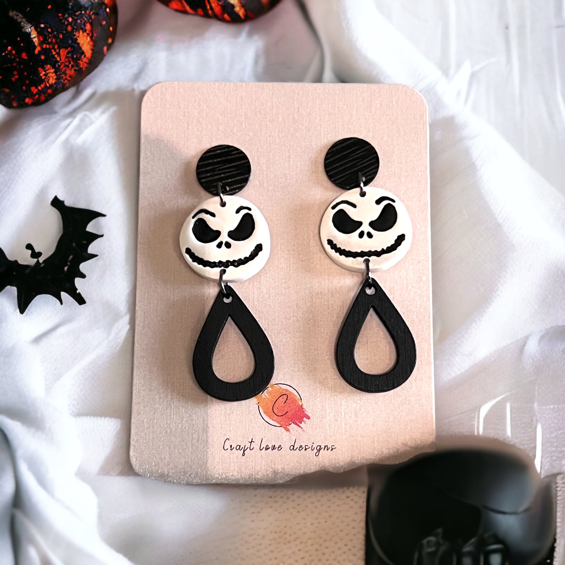 Spooky Black and White “Jack” dangle earrings on display, highlighting teardrop accents and playful Halloween design.