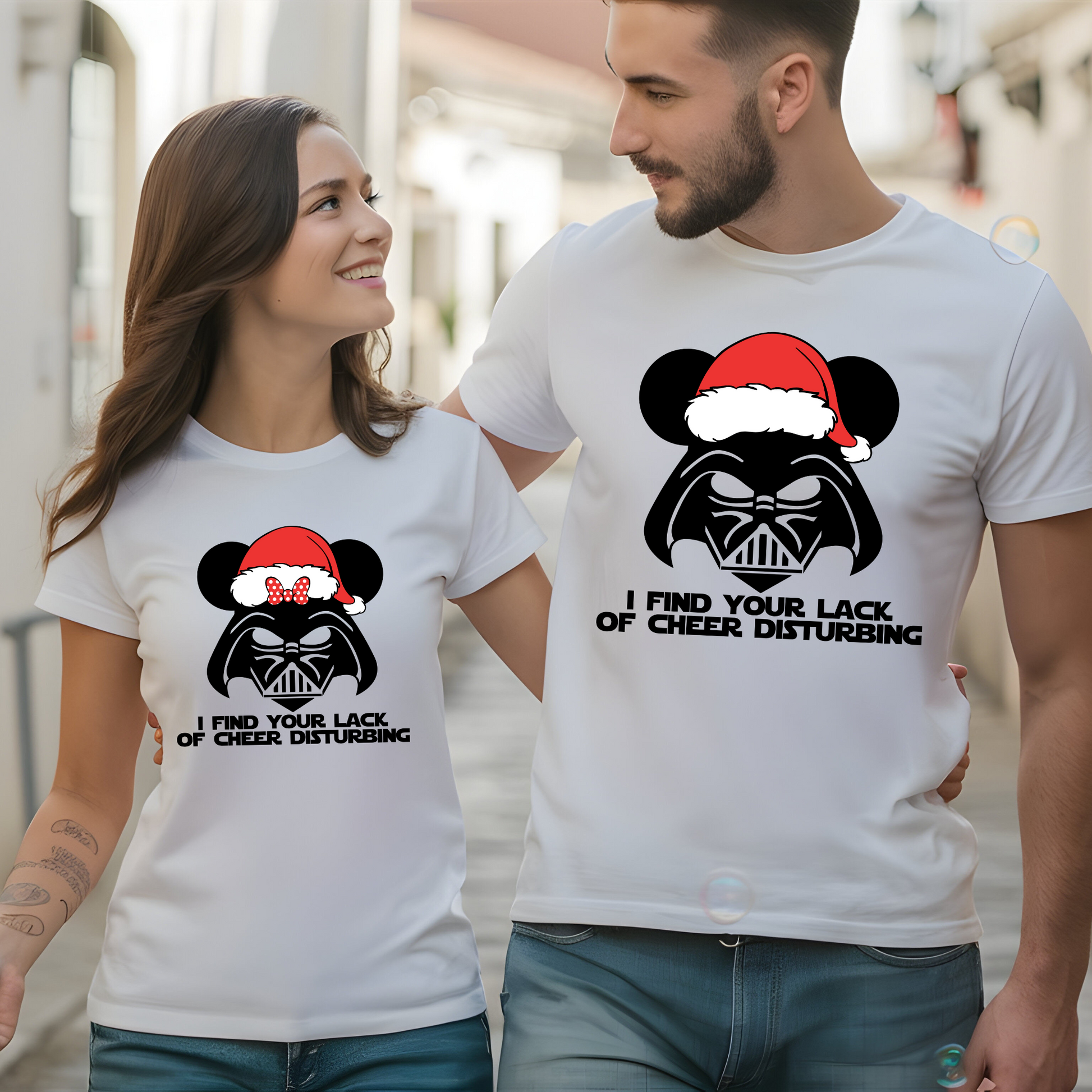 A couple wearing matching white t-shirts with a Darth Vader-inspired design, mouse ears, and a Santa hat, perfect for the holiday season.