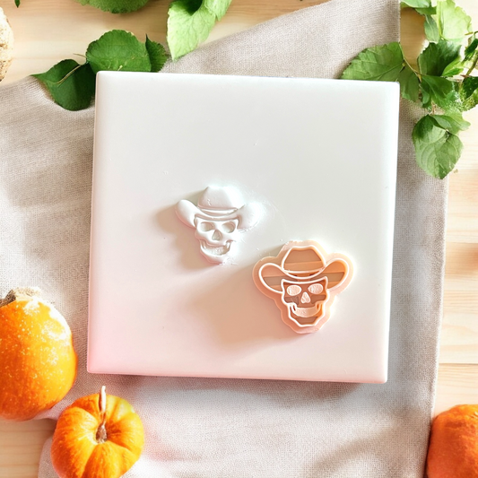 Polymer clay cutter next to cowboy skull impression on tile