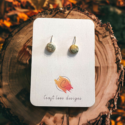 Earthy dangle earrings with beige and olive green hues, offering a rustic fall-inspired design with nature-driven texture.