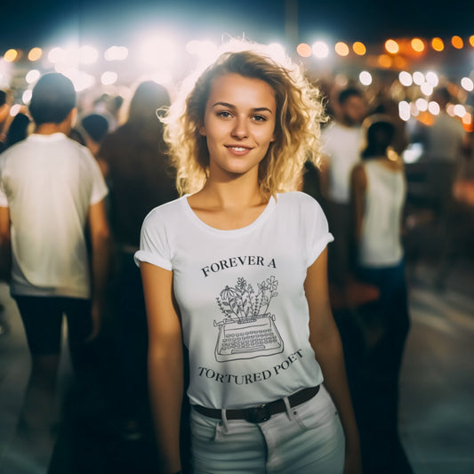 Woman wearing a white t-shirt featuring black line art of a typewriter with flowers and the text "Forever a Tortured Poet."