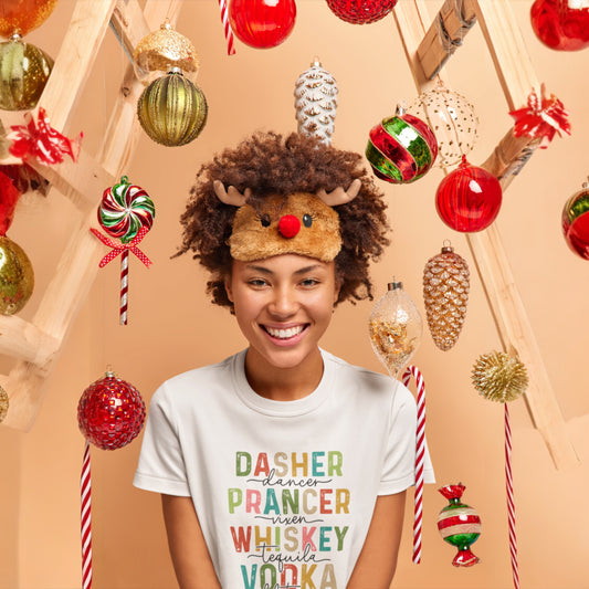 Girl wearing a white holiday t-shirt with colorful text listing reindeer names and drinks, perfect for fun Christmas celebrations.