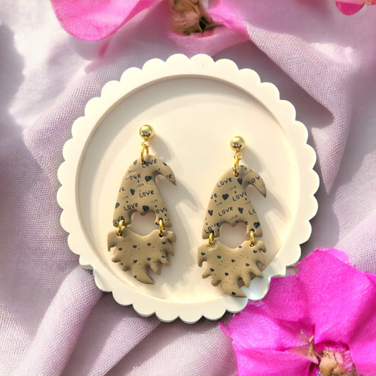 Latte Valentine gnome dangle earrings featuring heart and love patterns on beige polymer clay 