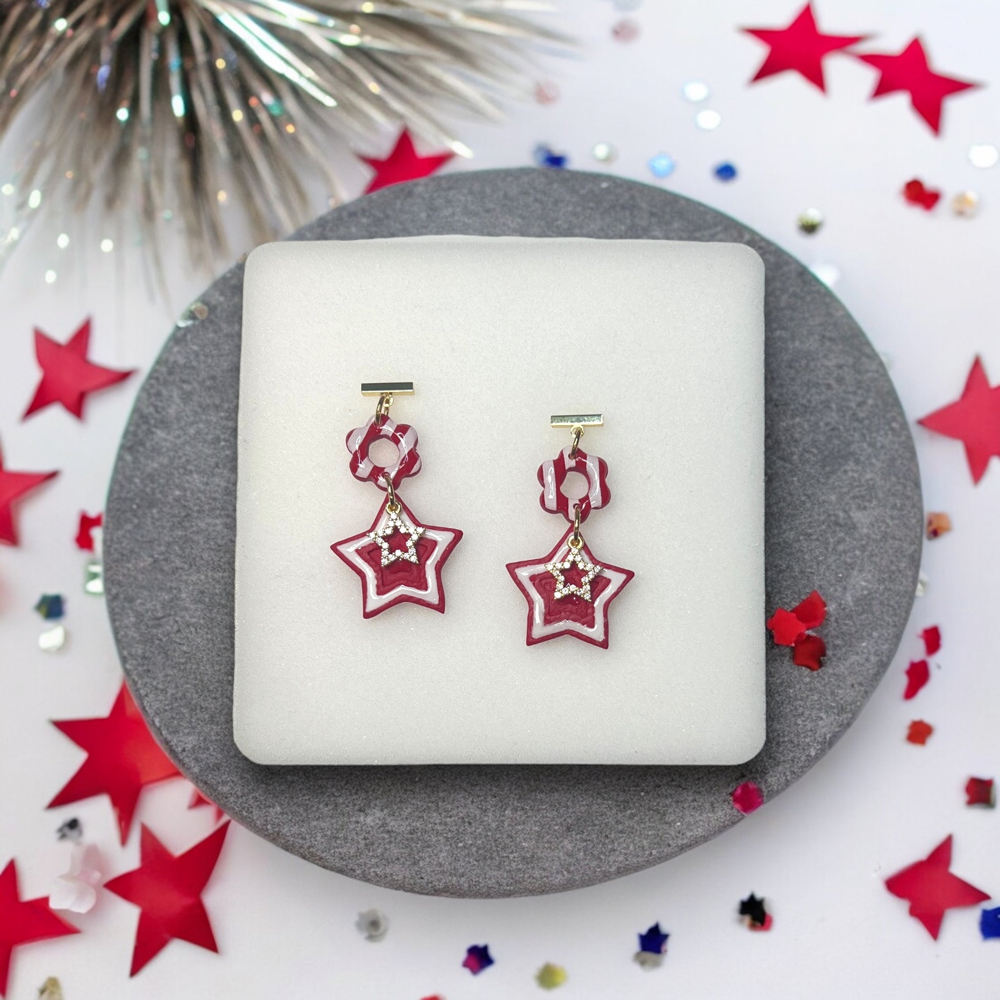 Red festive 4th of July polymer clay dangle earrings with bold, vibrant details, perfect for patriotic holiday celebrations