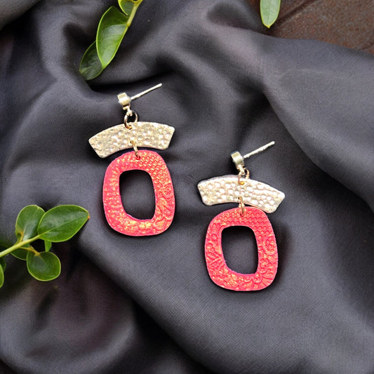  Elegant red and gold organic dangle earrings with textured design, featuring a unique handcrafted look on a soft dark fabric. (145)
Title: Handcrafted Red Drop Earrings