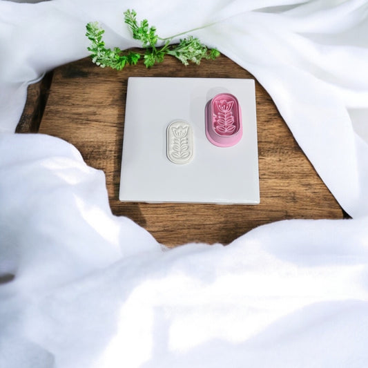 Pink floral clay cutter shown with matching pressed clay shape