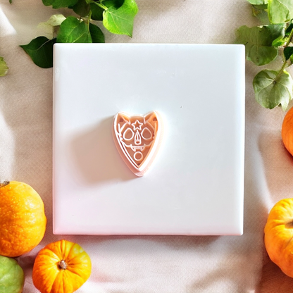 Pink sugar skull cat cutter shown close-up with festive fall styling