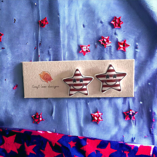 Smiling star stud earrings in classic red, white, and blue stripes with a playful design, ideal for Independence Day or themed outfits.