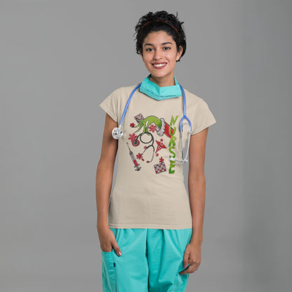 Woman wearing a beige Grinch nurse t-shirt with holiday medical designs, styled with scrubs and a stethoscope for a fun festive look.