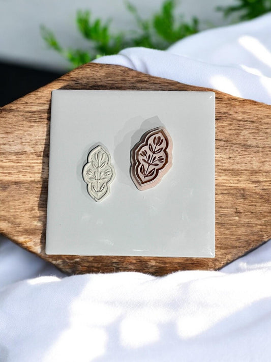 Embossed clay cutter shown next to matching pressed clay result