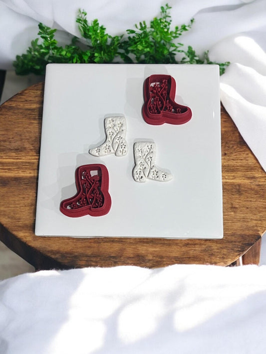 Red clay cutters shown next to matching pressed floral boot shapes
