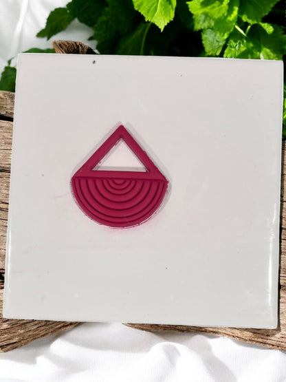 Finished clay shape with triangle and half-circle detail