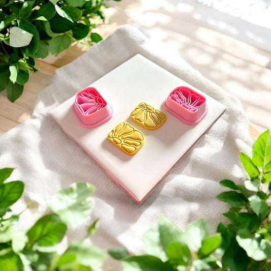 clay flowers next to matching pink cutters