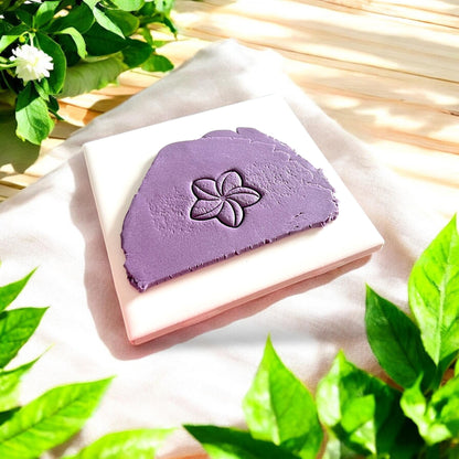 purple clay slab with plumeria flower imprint