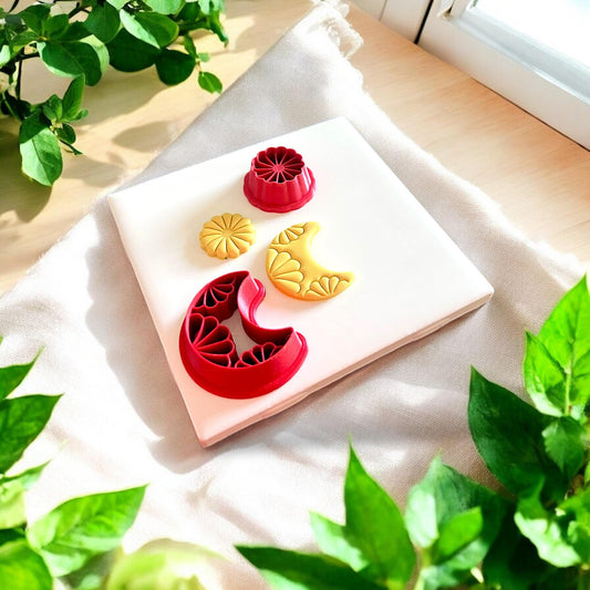 moon and sun clay shapes with red cutters