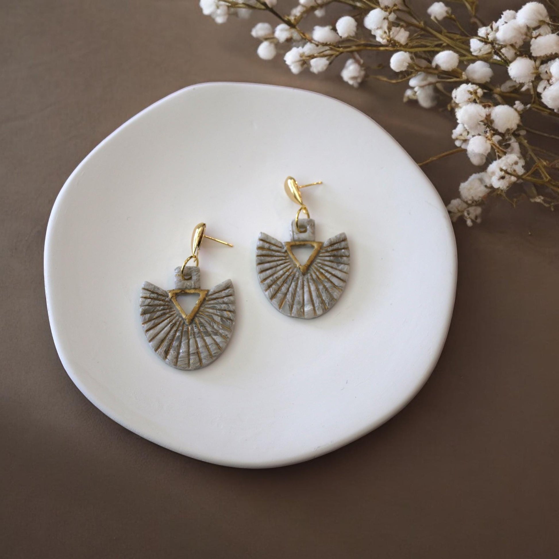 Clay earrings on display dish
