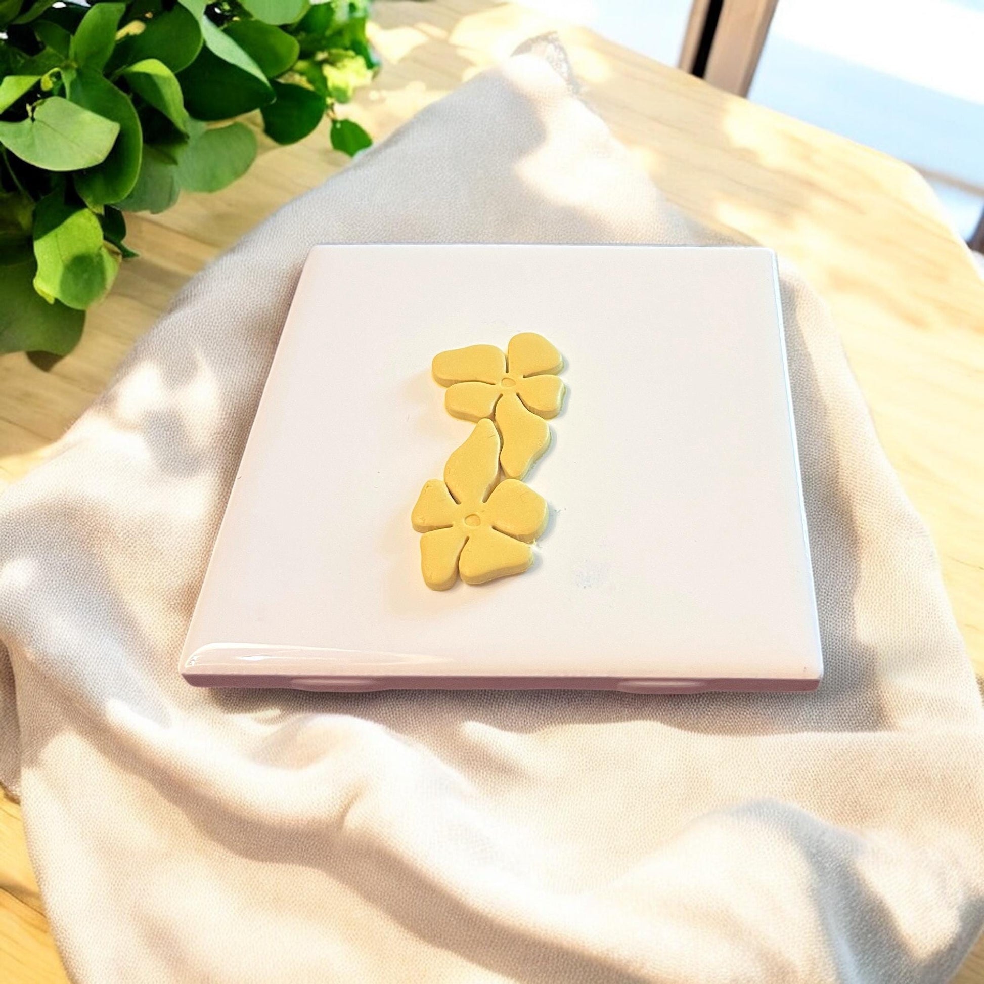 A pair of finished clay flower pieces with interlocking petals, perfect for making floral dangle earrings