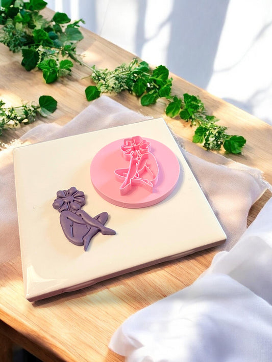 Side-by-side of a floral head girl cutter and the clay shape it creates for handmade charms or artistic earrings
