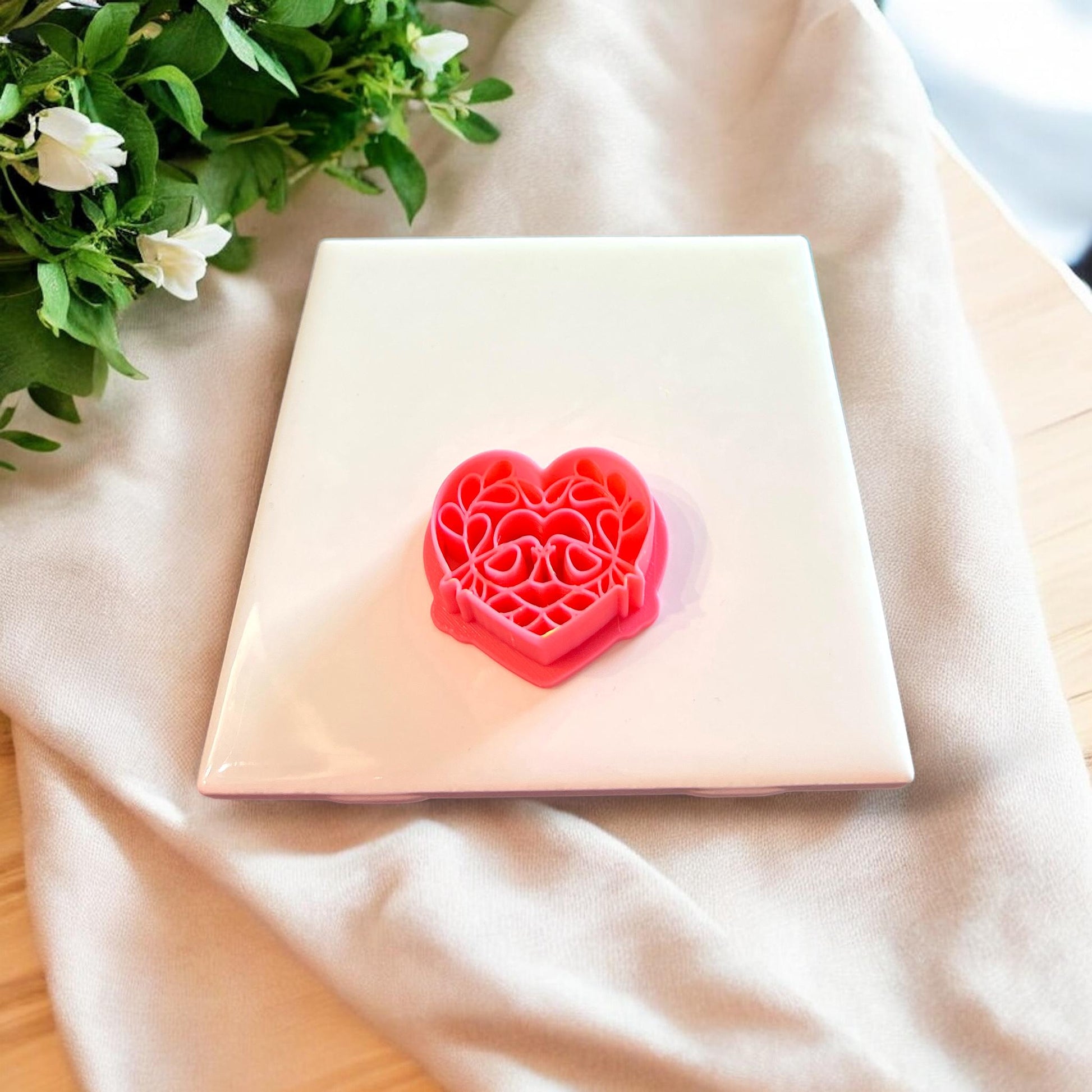 Close-up of the pink polymer clay cutter with love bird and floral detailing.