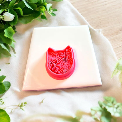 Side angle of the detailed floral kitty cutter, highlighting its precision and intricate design.