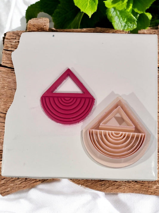 Completed clay piece and corresponding beige cutter side by side