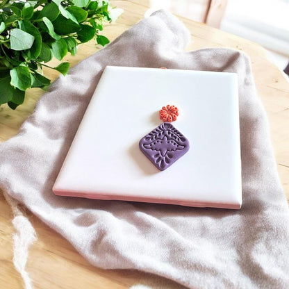 Close-up of an Aztec-inspired bird clay stamp impression, ideal for boho and tribal-style polymer clay earrings