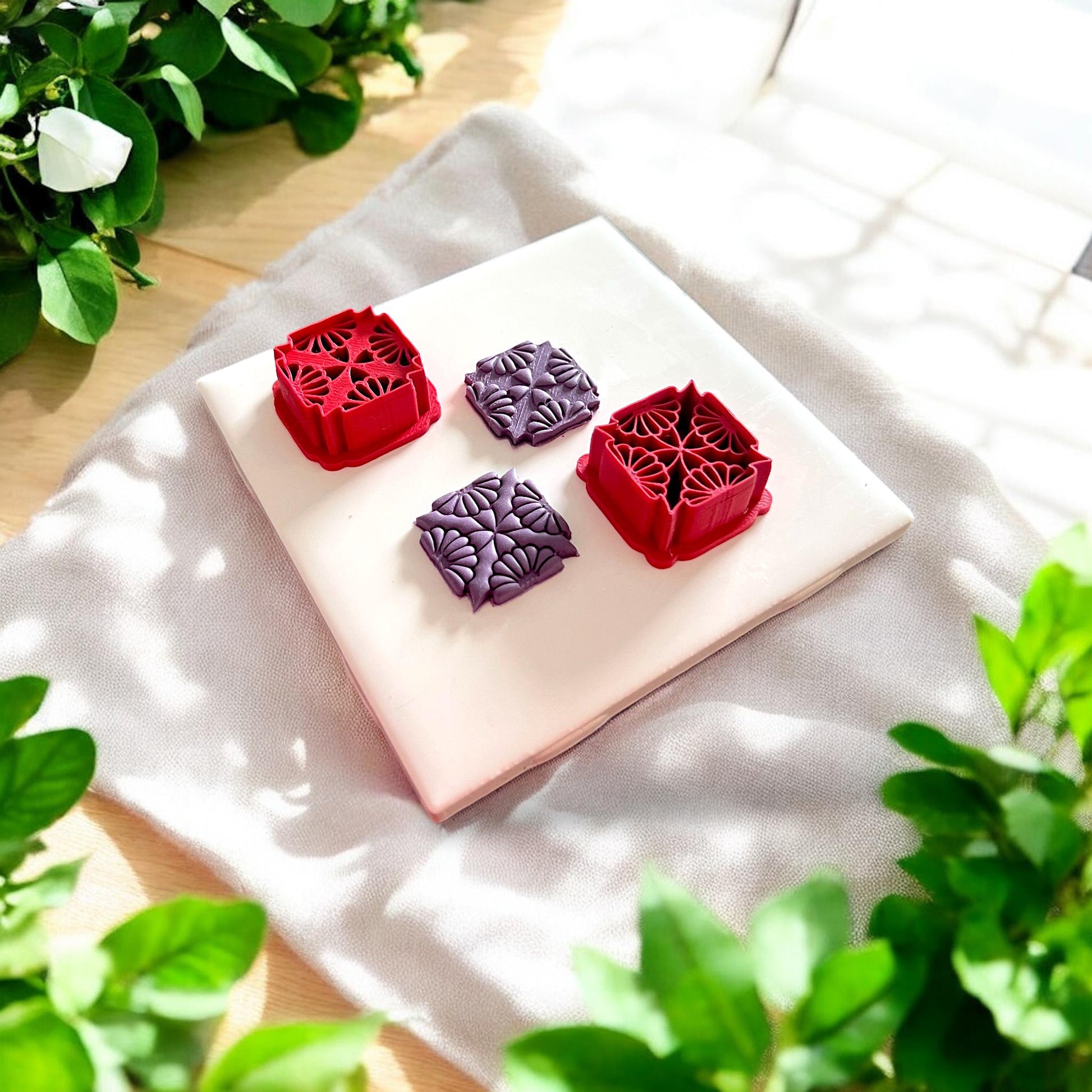 two purple clay pieces with matching red cutters