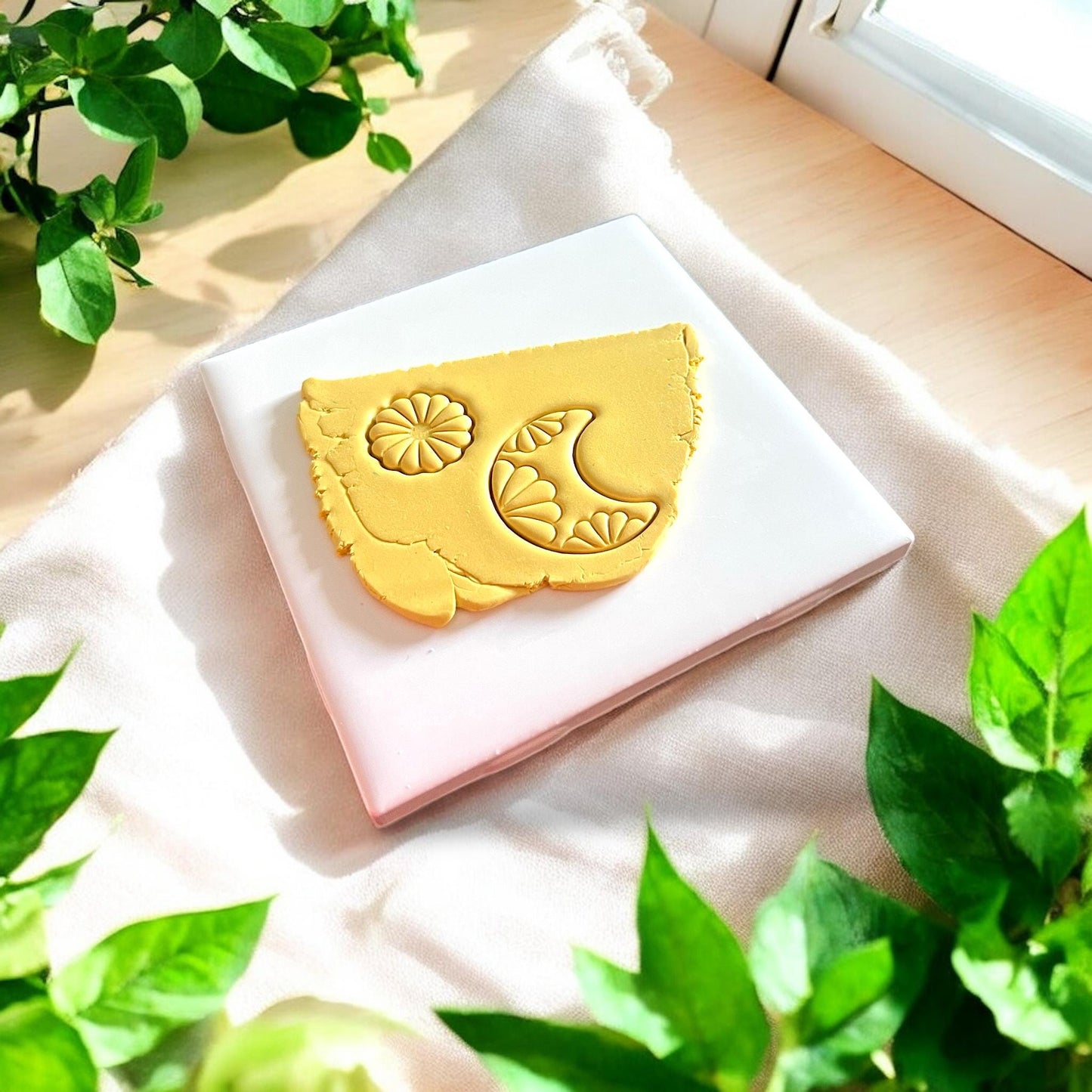 clay impression of floral moon and sun shapes