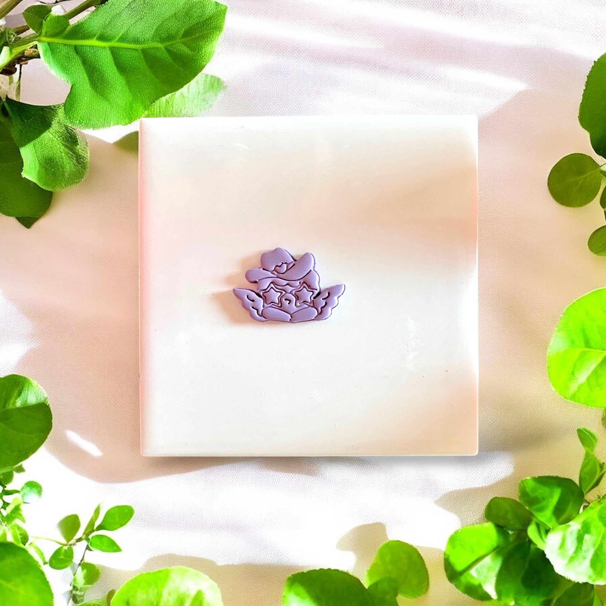 Impression of the western cupid cutter on a slab of polymer clay, showcasing detailed design elements.